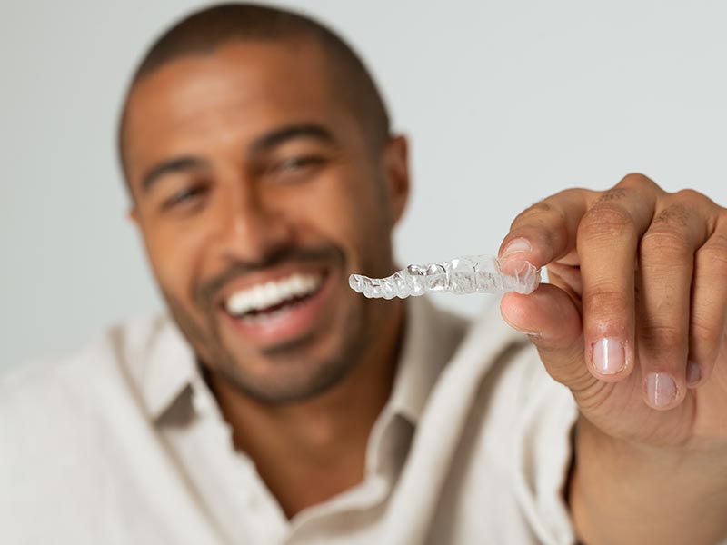 Man holding aligner