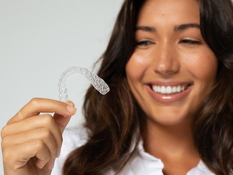 Woman holding aligner