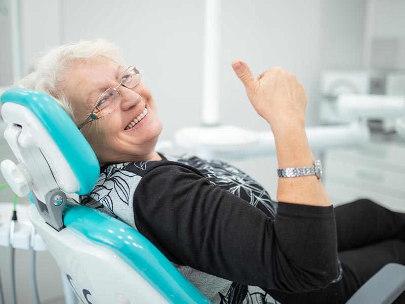 Middle aged woman smiling in dental treatment room