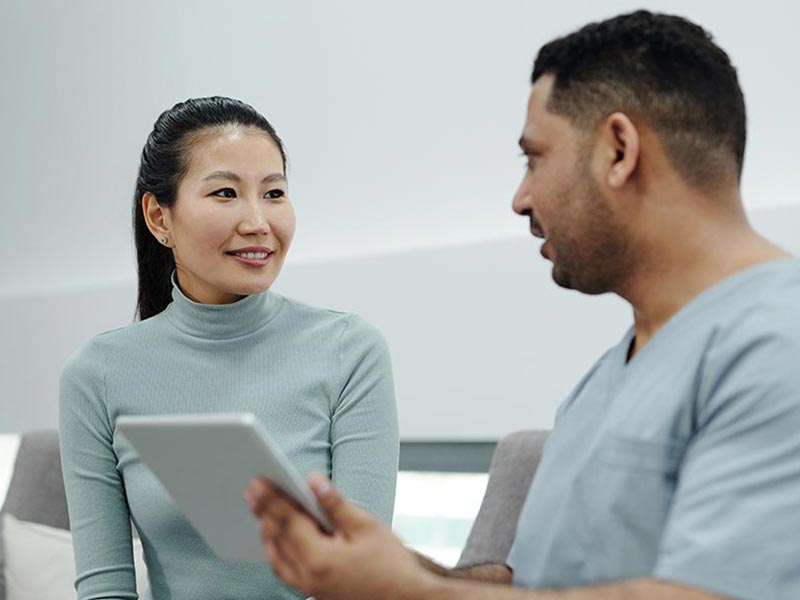A dentist talking with a woman