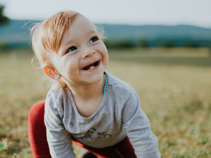 Crawling baby with 2 small teeth