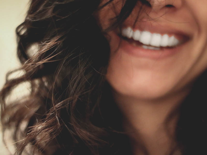 Blurred woman with whitened teeth smiling