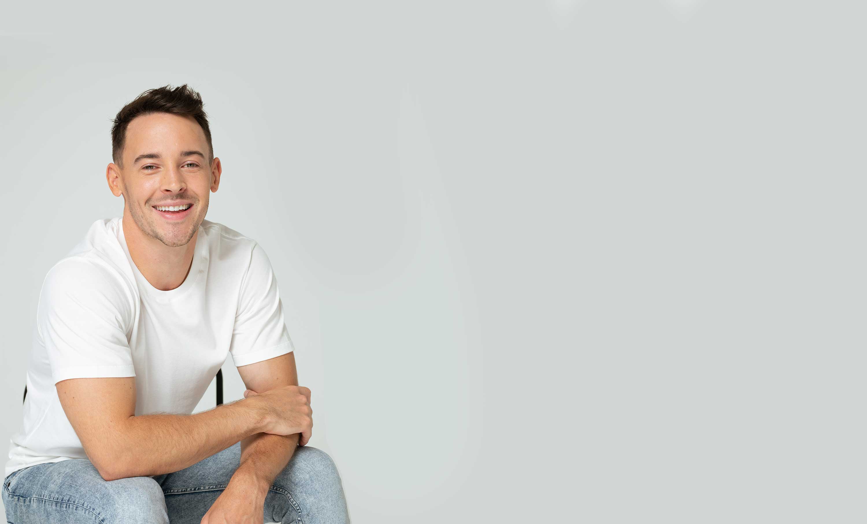 Man with folded arms smiling