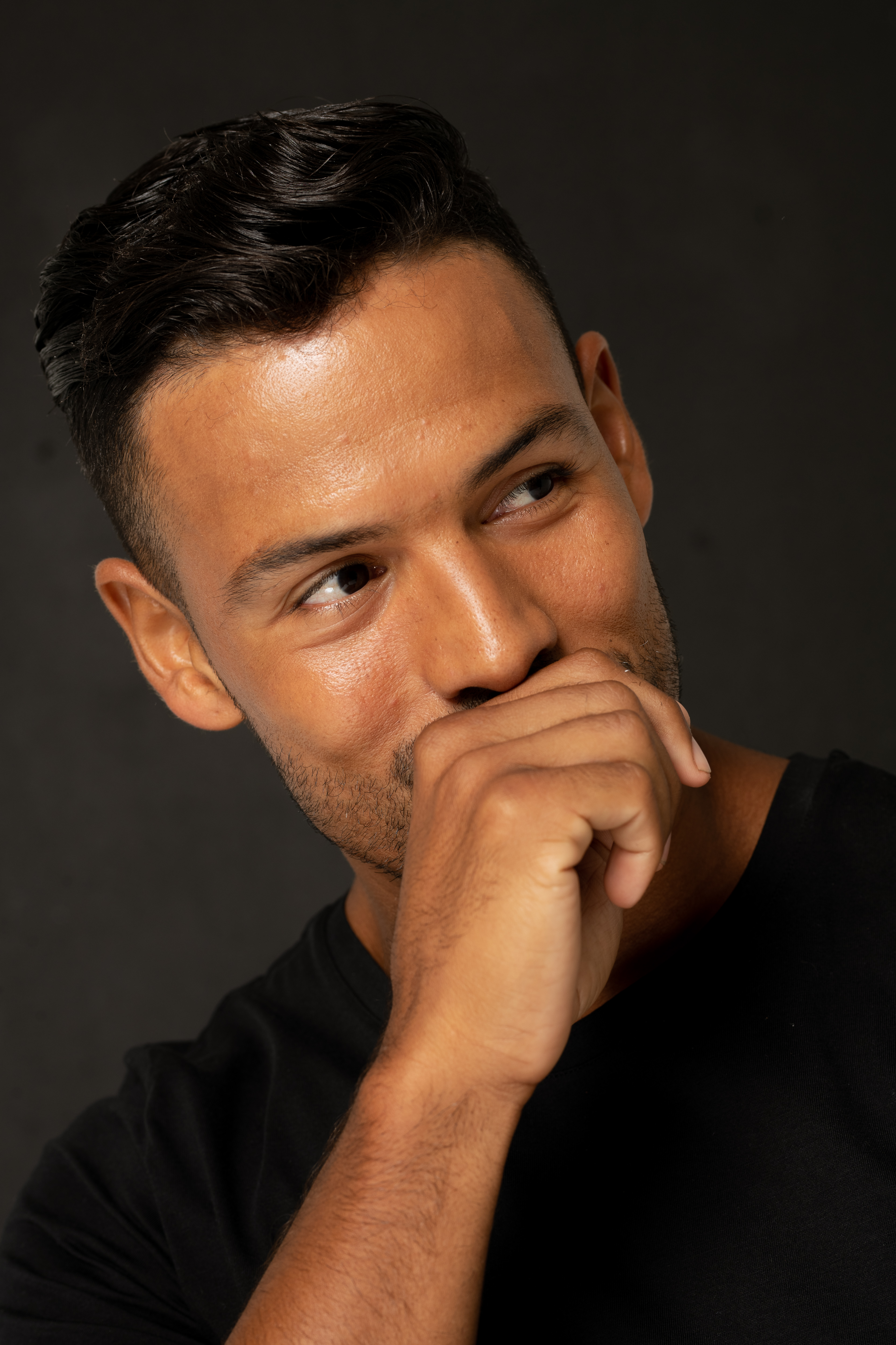 Man covering his smile with his hand