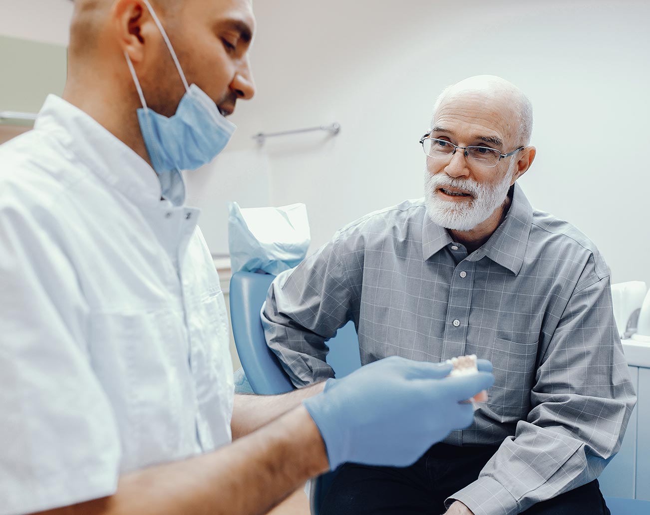 Middle aged man talking to a dentist